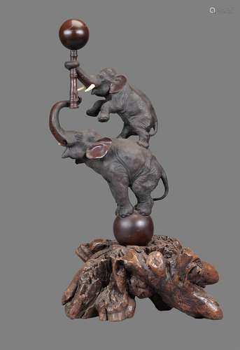 A Japanese Bronze Group of an Elephant Balanced on a Ball