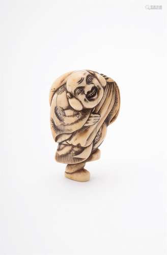 A Japanese Ivory Netsuke carved as Hotei