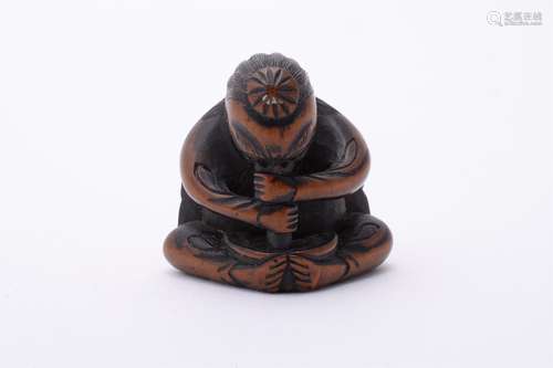 A Wood Netsuke carved in the form of a Tengu