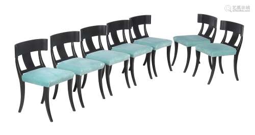 A set of fourteen ebonised dining chairs