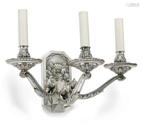 A pair of silver coloured alloy metal three light wall appliqués in Art Deco style