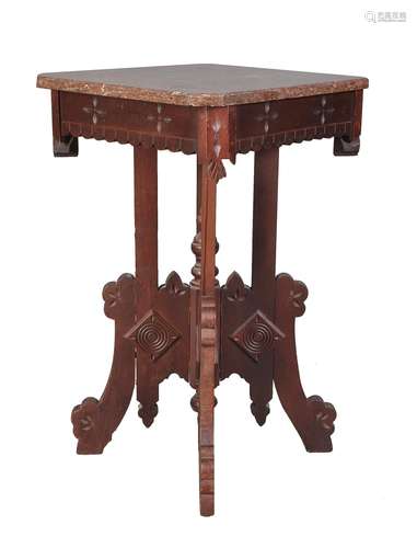 A carved and stained walnut occasional table