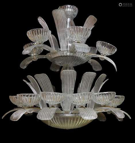 A large moulded clear glass seventeen light chandelier in Art Deco style