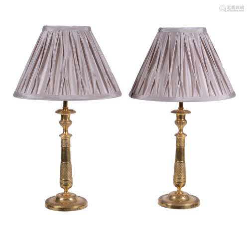 A pair of French gilt metal candlesticks in Empire style