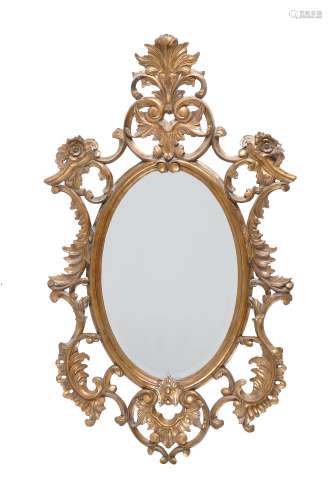 A carved gilt framed oval wall mirror in George III style