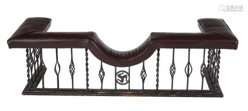 A wrought iron and leather upholstered club fender