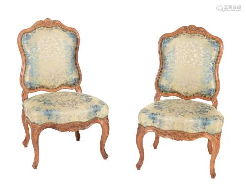 A pair of walnut and upholstered side chairs