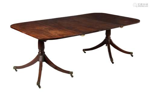 A mahogany twin pillar extending dining table