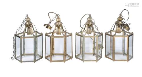 A set of four gilt metal and glazed hexagonal hall lanterns