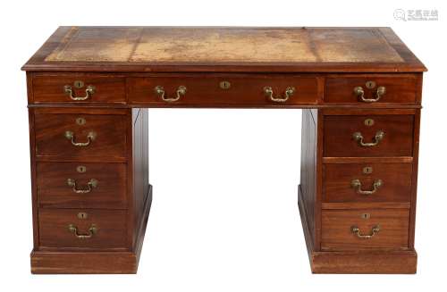 An Edwardian mahogany and leather inset pedestal desk