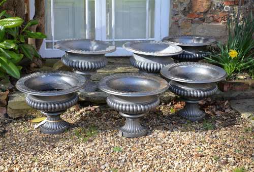 A set of six Victorian painted cast iron urns