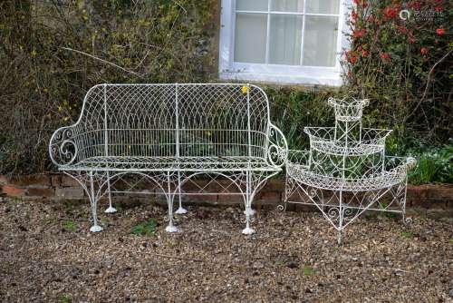 A white painted wrought metal garden seat