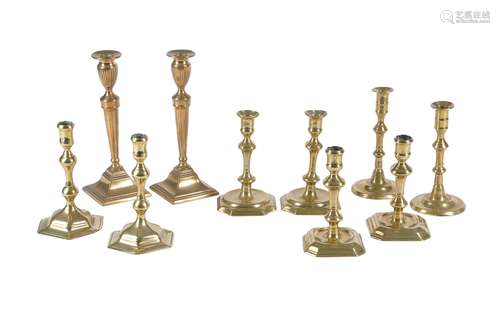 Five various pairs of cast brass candlesticks