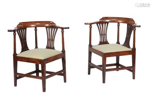 A pair of George III mahogany corner armchairs