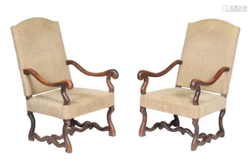 A pair of French oak and upholstered armchairs