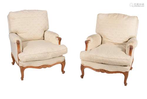 A pair of French carved beech and upholstered armchairs