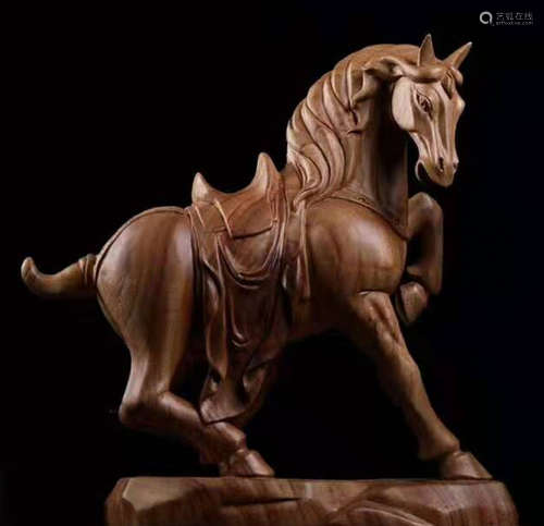 A XIANGZHANG WOOD CARVED HORSE SHAPED ORNAMENT