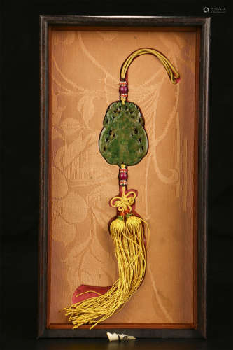 A CHINESE CARVED JADEITE PENDANT