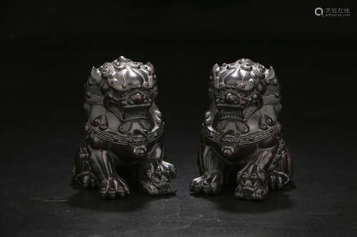 A PAIR OF CHINESE ROSEWOOD LION ORNAMENTS