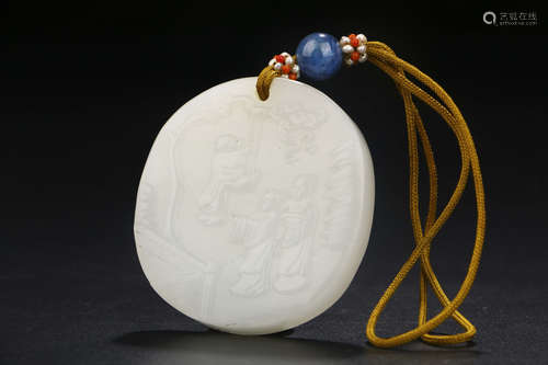 A CHINESE CARVED HETIAN JADE PENDANT