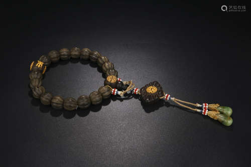 A CHINESE GILT EAGLEWOOD BEADS HAND STRING