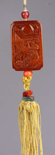 AN AMBER TABLET CARVED WITH CRANE AND DEER