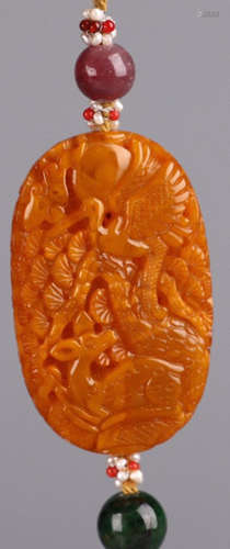 AN AMBER TABLET CARVED WITH CRANE AND DEER