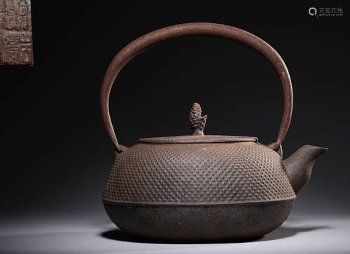 AN IRON POT CARVED WITH PATTERN