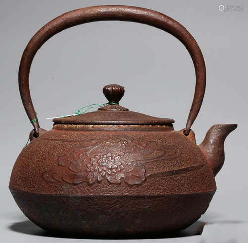 AN IRON POT CARVED WITH FLOWER