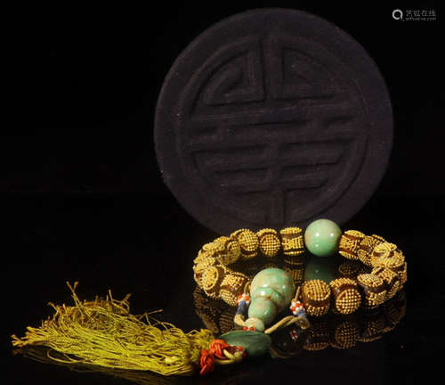 A CHENXIANG WOOD BANGLE EMBEDED WITH GOLD BEADS