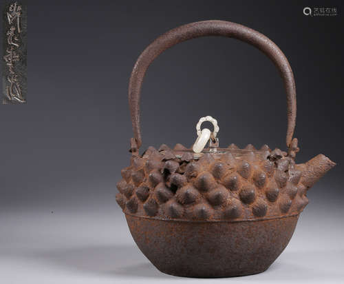 AN IRON POT WITH CARVING