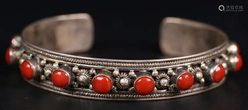 A SILVER CASTED BANGLE WITH CORAL