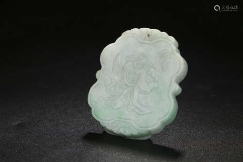 A CHINESE CARVED JADEITE PENDANT