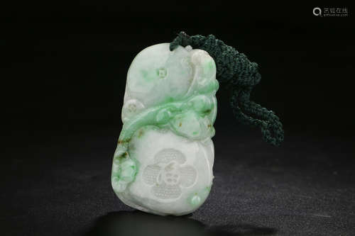 A CHINESE CARVED JADEITE PENDANT