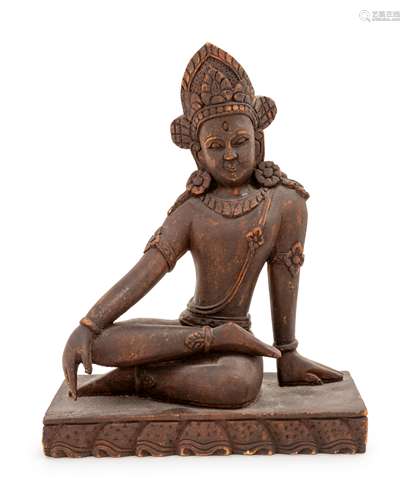 An Indian Carved Wood Figure of a Seated Deity Height