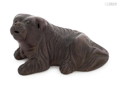 A Chinese Yixing Pottery Figure of a Recumbent Dog