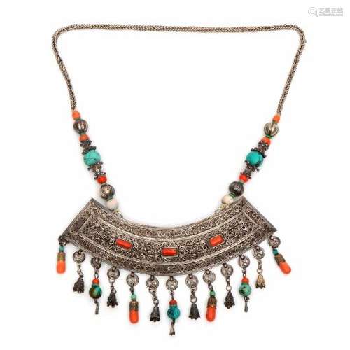 Mongolia, necklace with broad pendant,with filigree wave patterns, inlaid coral and decorated with