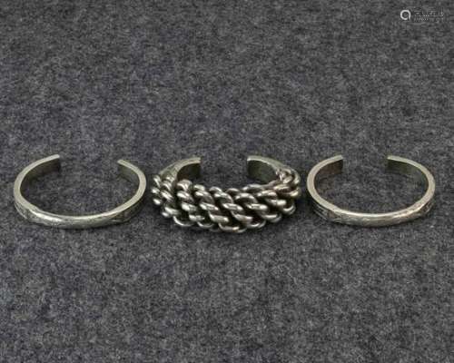 Golden Triangle, silver bracelet and a pair of solid bracelets;the twisted bracelet is worn in