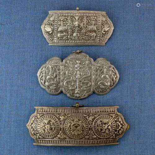 Tibet, three silver cloak pins the hammered pins depict snakes, birds, fish, mythological