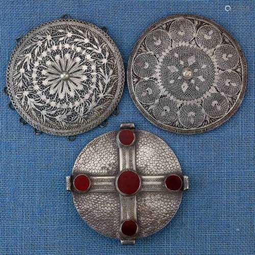 Turkmenistan, two silver filigree front pieces and a silver pectoral diskthe fine filligree work