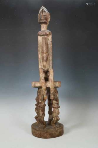 Dogon, seated female figureon a stool carried by four standing female figures., h. 85 cm. [1]400
