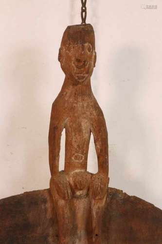 PNG, Asmat, small shield with anthropomorphic figure on top,decorations in white, red and black