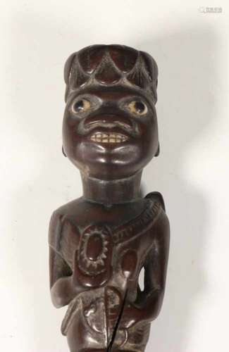 Indonesia, knife with a carved wooden hilt in the shape of a figure, ca. 1930,with inlaid eyes and