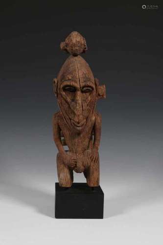 PNG, Sepik wooden boat fragment;in the form of a standing ancestral figure with a reptile on the