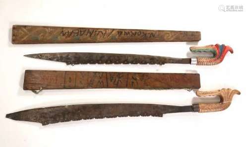 Papua, Teluk Cendrawasih, Biak, two parang,both swords with inlay and wooden grips in the form of