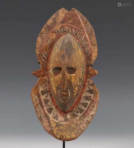 PNG, Abelam, carved small wooden yam spirit maskwith disc shaped hairstyles and painted patterns