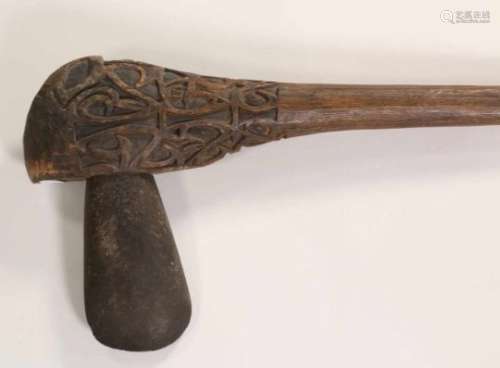Papua, Asmat, axe,the carved wooden axe hilt with intricate carving at the top and a standing