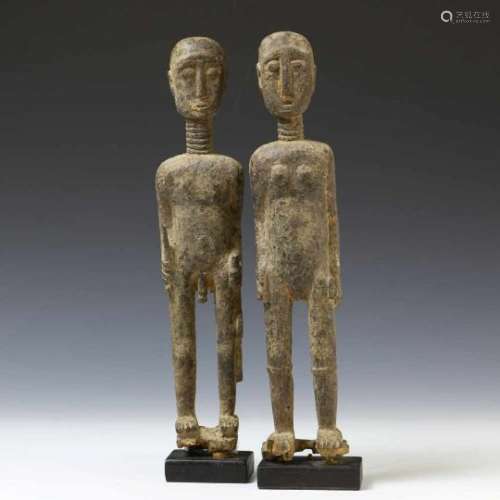 Ghana, Akan, a standing male and female figure. The male figure with a knife and a rifle in the