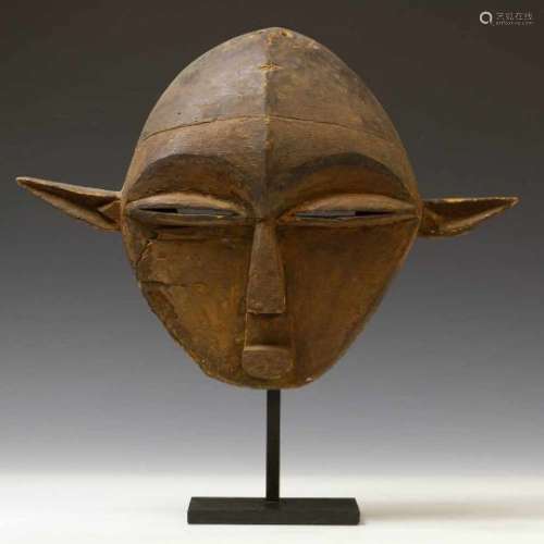 East Pende, face mask,with split eyes and pointy ears. With brown patina and accents in black.