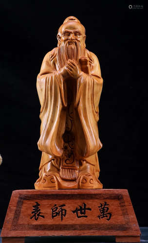 A THUJIA WOOD CARVED KONGZI FIGURE